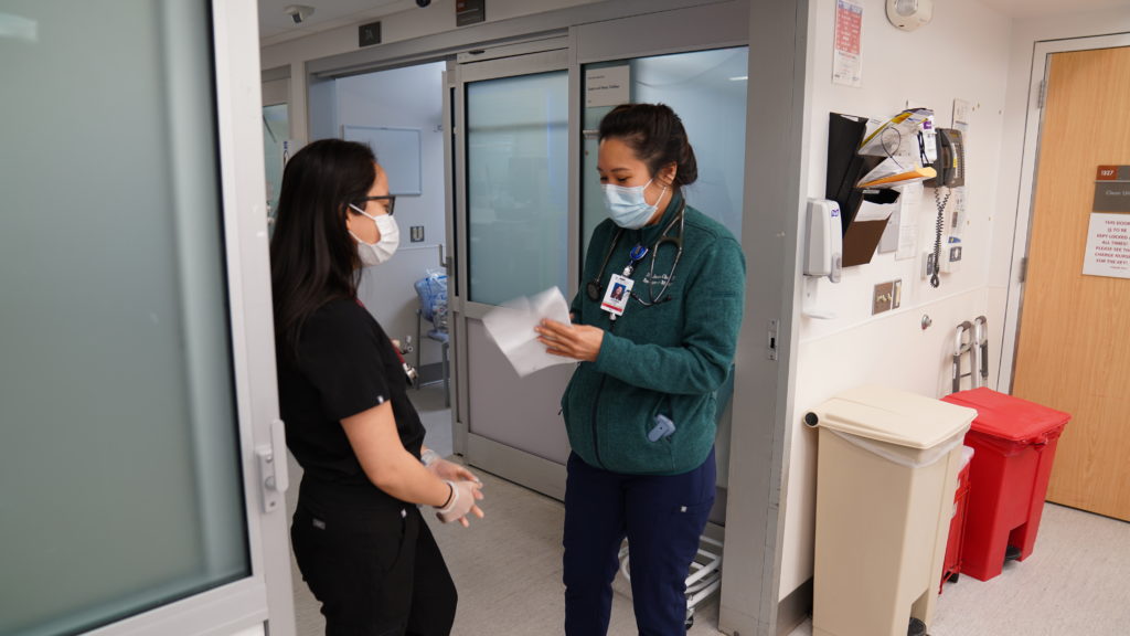 Two female doctors reviewing reports together in the Emergency Room